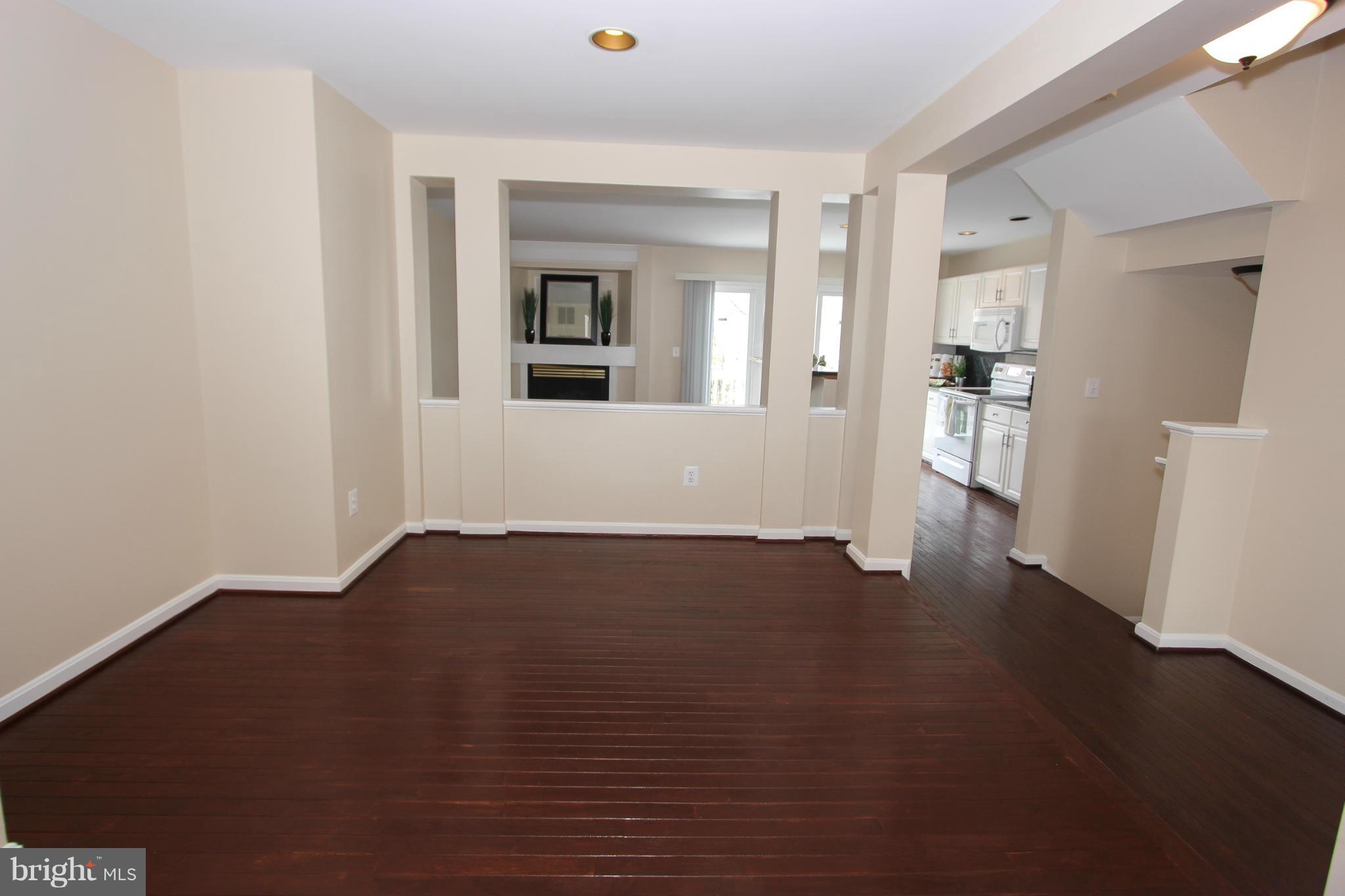 1706 Random Stone Court Reston, VA 20190 - Photo 23 of 30 a view of an empty room with wooden floor and a window