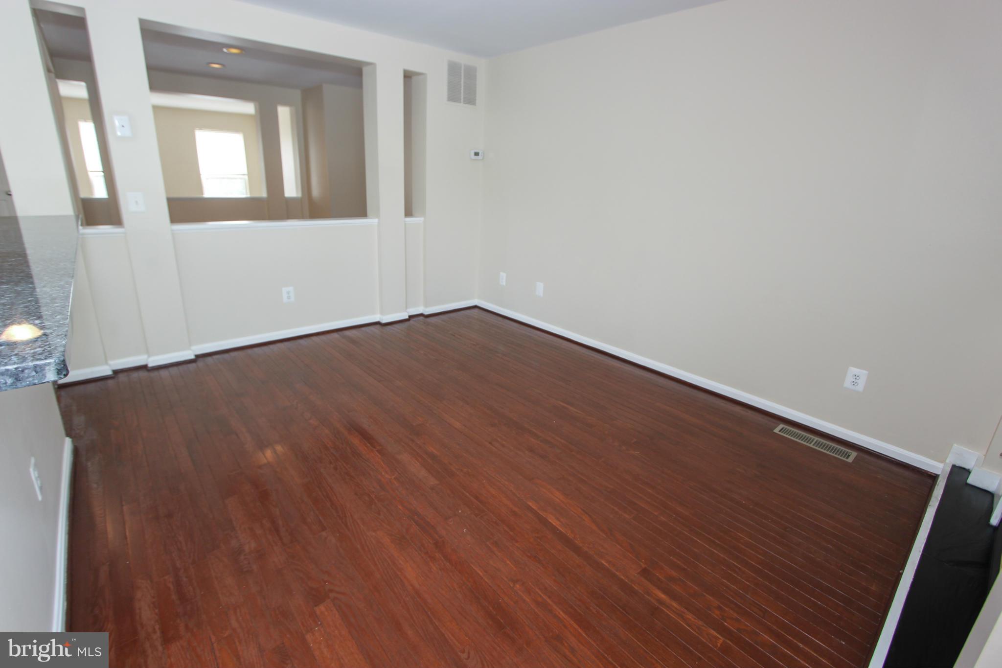 1706 Random Stone Court Reston, VA 20190 - Photo 24 of 30 a view of an empty room with wooden floor and a window