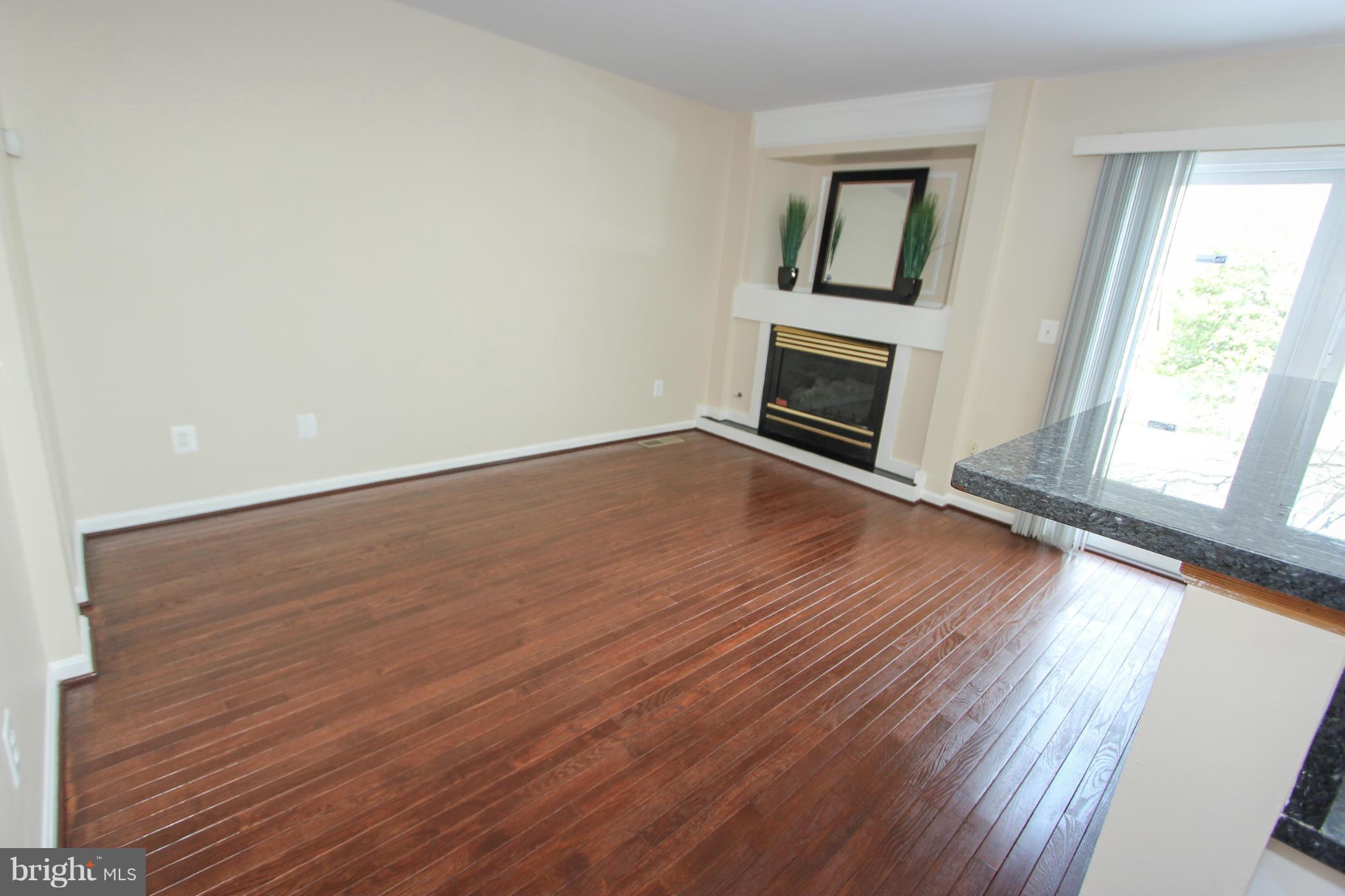 1706 Random Stone Court Reston, VA 20190 - Photo 26 of 30 an empty room with wooden floor and windows