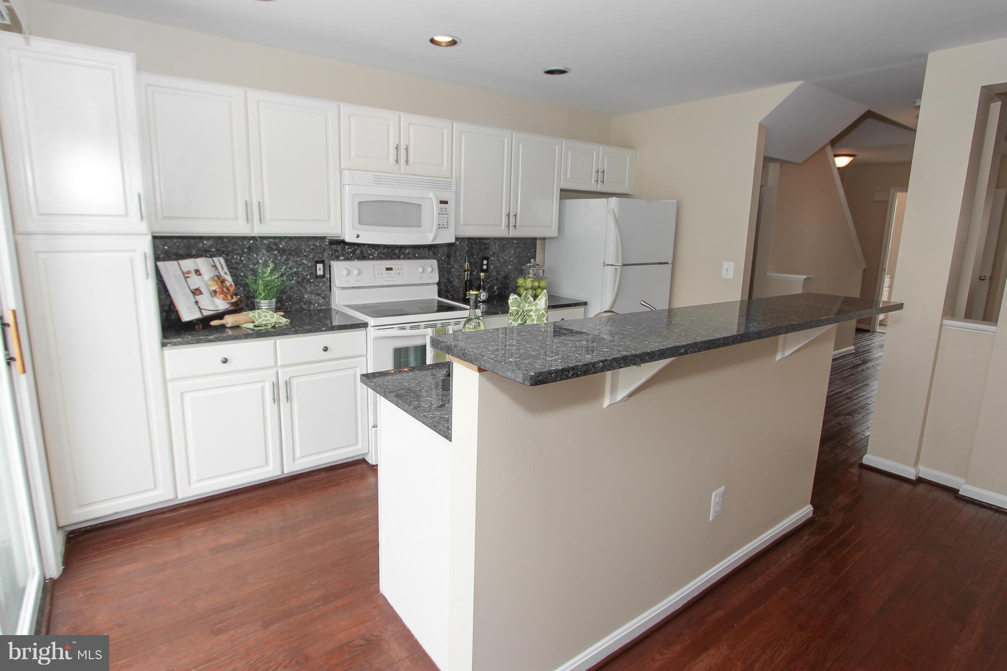 1706 Random Stone Court Reston, VA 20190 - Photo 28 of 30 a kitchen with white cabinets and sink