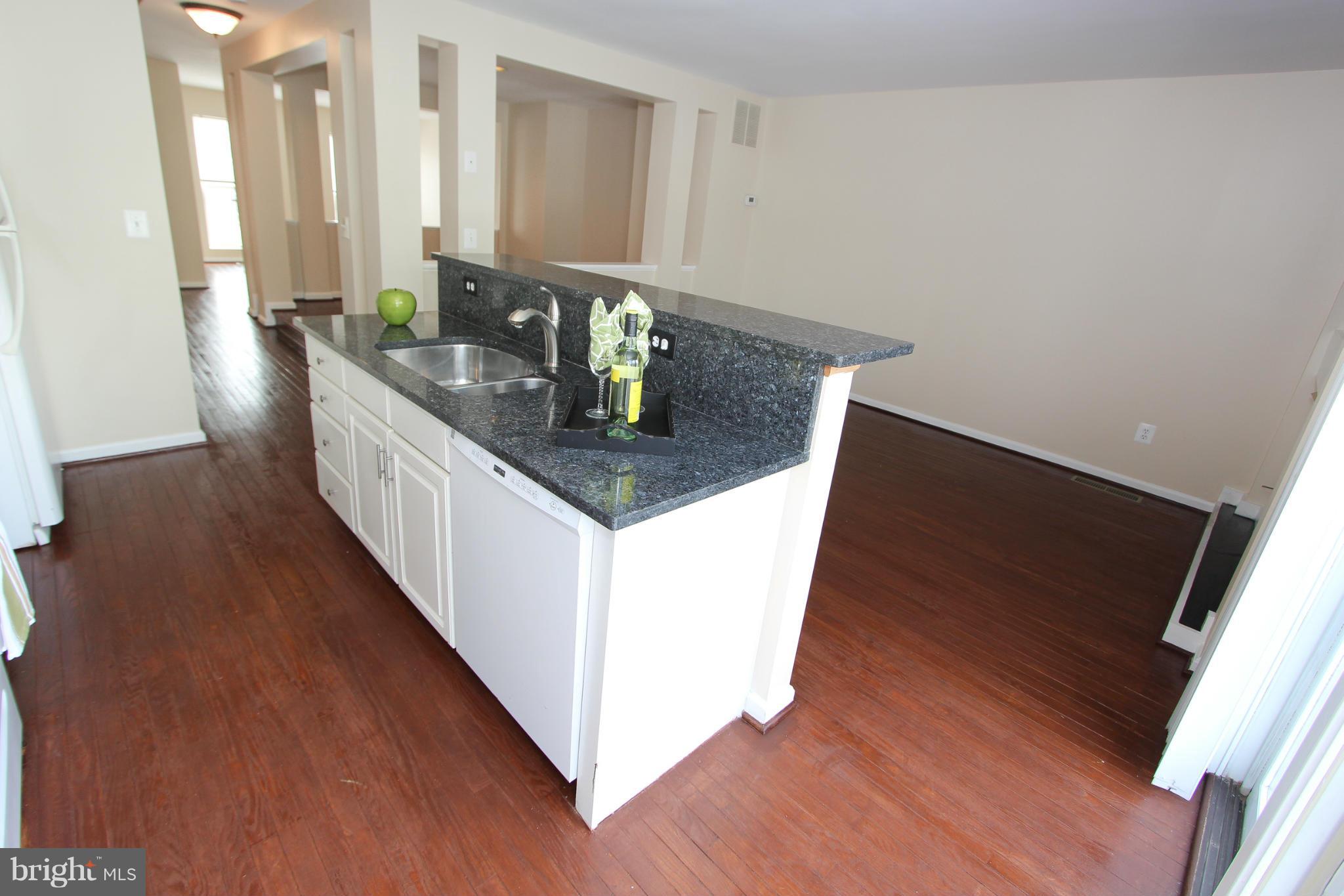 1706 Random Stone Court Reston, VA 20190 - Photo 30 of 30 a hallway with sink and wooden floor