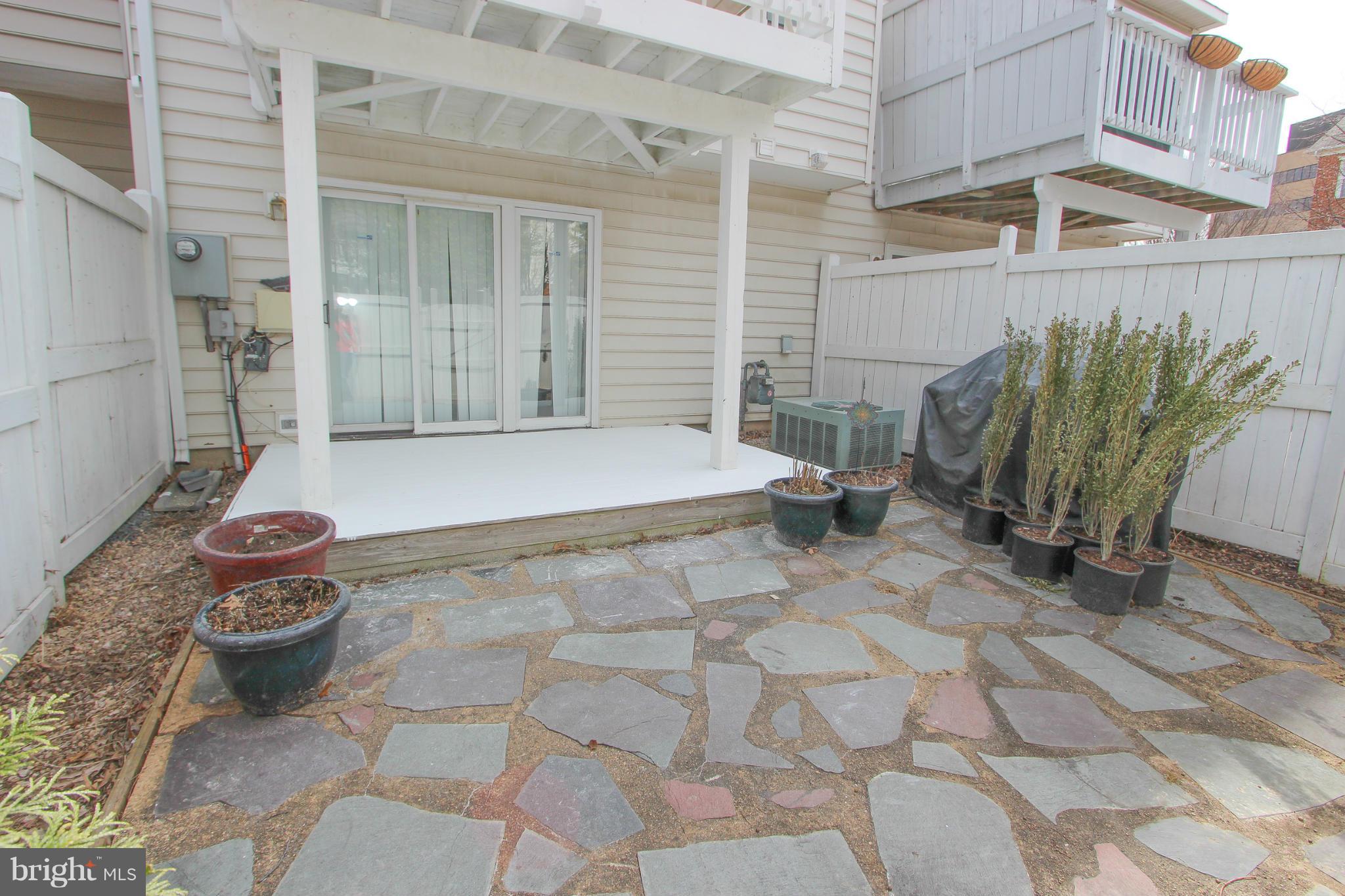 1706 Random Stone Court Reston, VA 20190 - Photo 5 of 30 a view of a backyard with table and chairs and potted plants