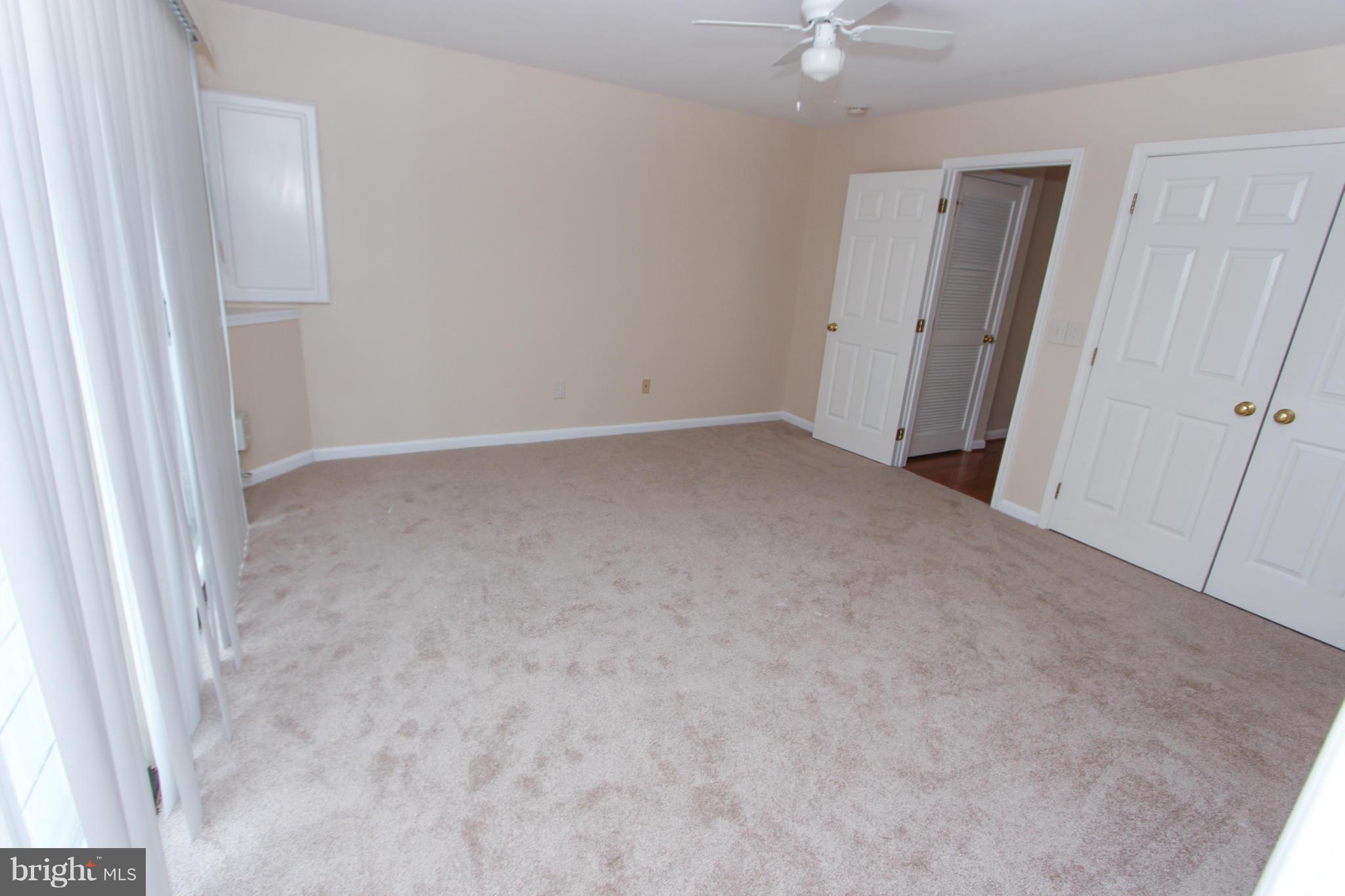 1706 Random Stone Court Reston, VA 20190 - Photo 6 of 30 an empty room with a ceiling fan and a window