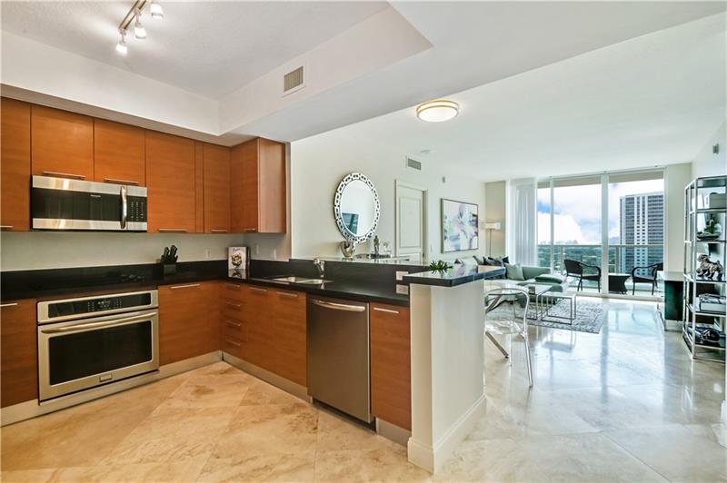 Open Gourmet kitchen with plenty of countertop & cabinetry space ... newer stainless steel appliances. Marble flooring (large tiles) throughout the residence.