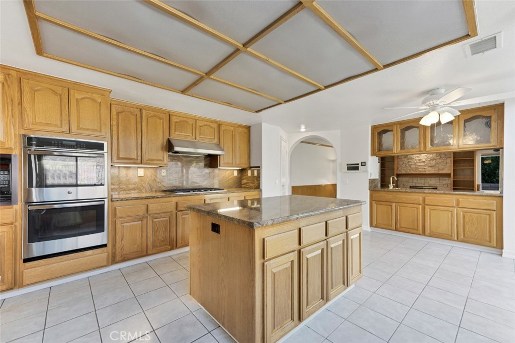 19641 Falcon Ridge Way Porter Ranch, CA 91326 - Photo 15 of 51 a kitchen with stainless steel appliances granite countertop a stove sink and cabinets