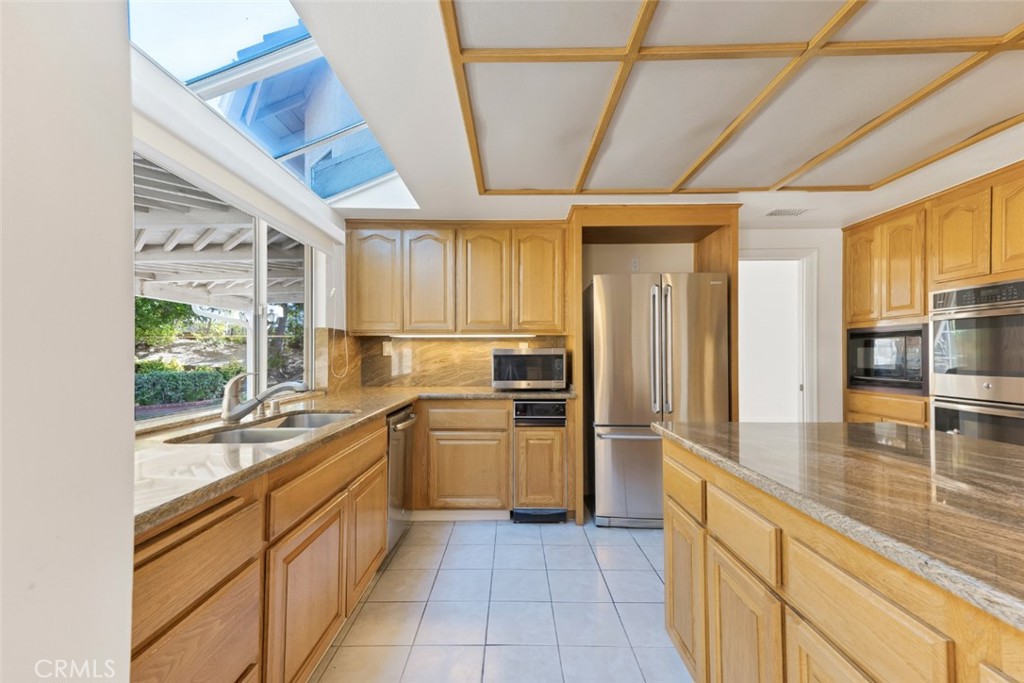 19641 Falcon Ridge Way Porter Ranch, CA 91326 - Photo 16 of 51 a kitchen with stainless steel appliances granite countertop lots of counter top space and wooden floor