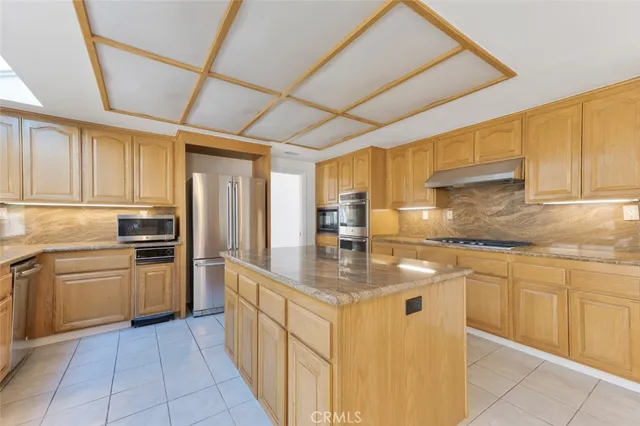 a kitchen with stainless steel appliances granite countertop a sink and cabinets