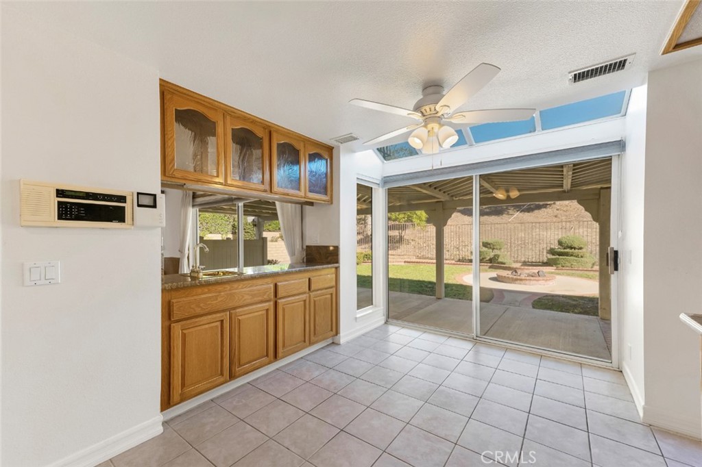 19641 Falcon Ridge Way Porter Ranch, CA 91326 - Photo 19 of 51 a large white kitchen with a sink and dishwasher a refrigerator with white cabinets