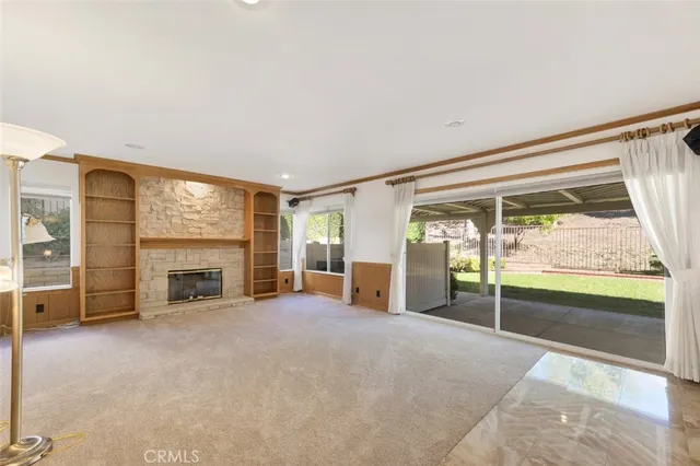 an empty room with furniture and a fireplace