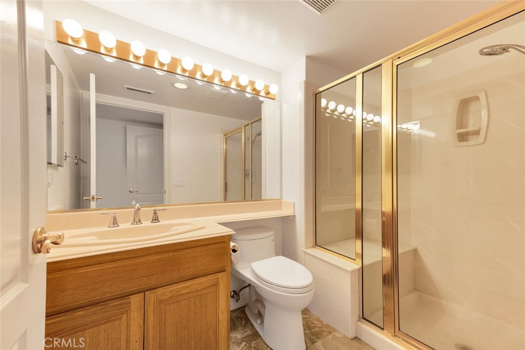 19641 Falcon Ridge Way Porter Ranch, CA 91326 - Photo 27 of 51 a bathroom with a sink a toilet and shower