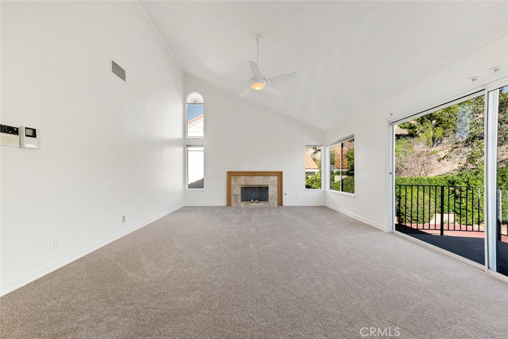 19641 Falcon Ridge Way Porter Ranch, CA 91326 - Photo 29 of 51 a view of a big room with windows and chandelier fan