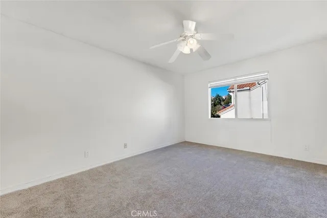 a view of a livingroom with wooden floor and a ceiling fan