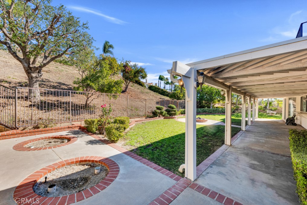 19641 Falcon Ridge Way Porter Ranch, CA 91326 - Photo 44 of 51 a view of a patio with table and chairs potted plants with wooden floor and fence