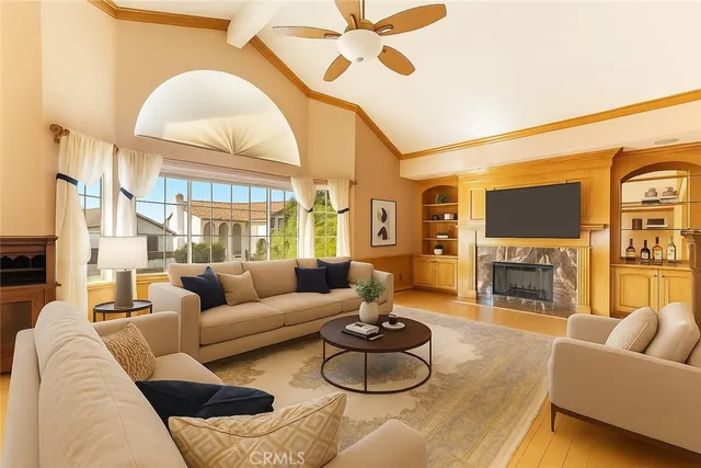 a living room with fireplace furniture and a large window