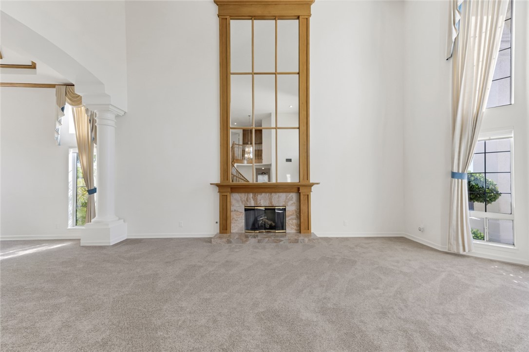 19641 Falcon Ridge Way Porter Ranch, CA 91326 - Photo 10 of 51 an empty room with windows and fireplace
