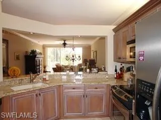 a kitchen with stainless steel appliances a sink stove and cabinets