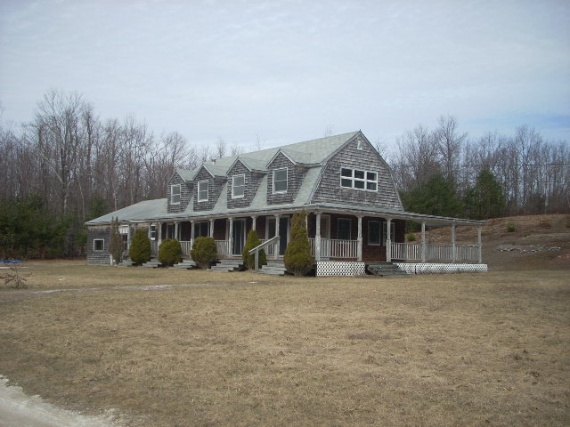 1122 Main Road Savoy, MA 01256 - Photo 1 of 2 a front view of a house with a garden