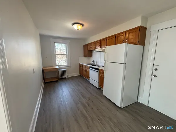a view of kitchen and wooden floor