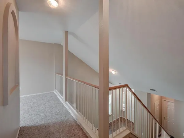 a view of a hallway with staircase