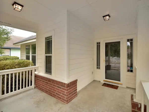 a view of backyard with a large window and wooden floor
