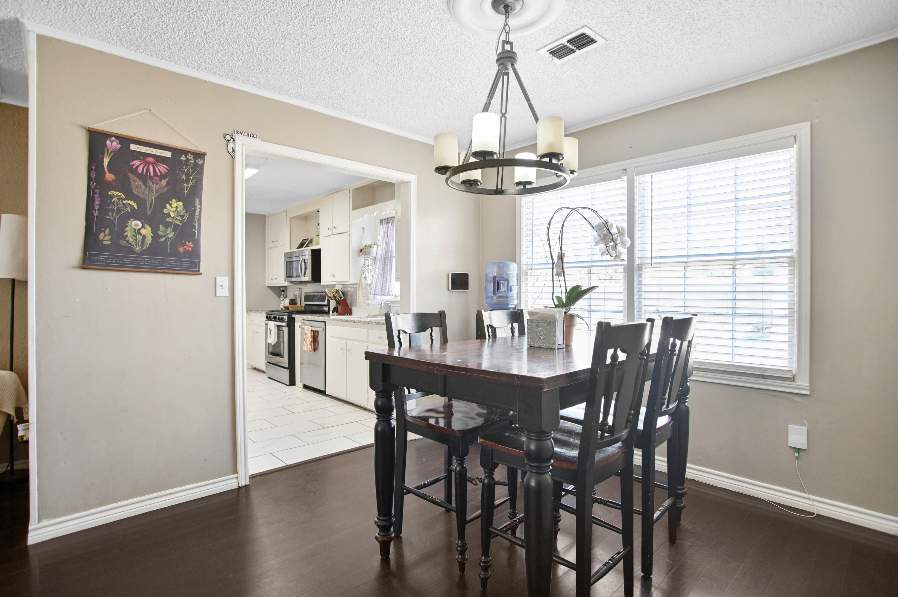 4102 32nd Street Lubbock, TX 79410 - Photo 11 of 40 a view of a dining room with furniture window and wooden floor