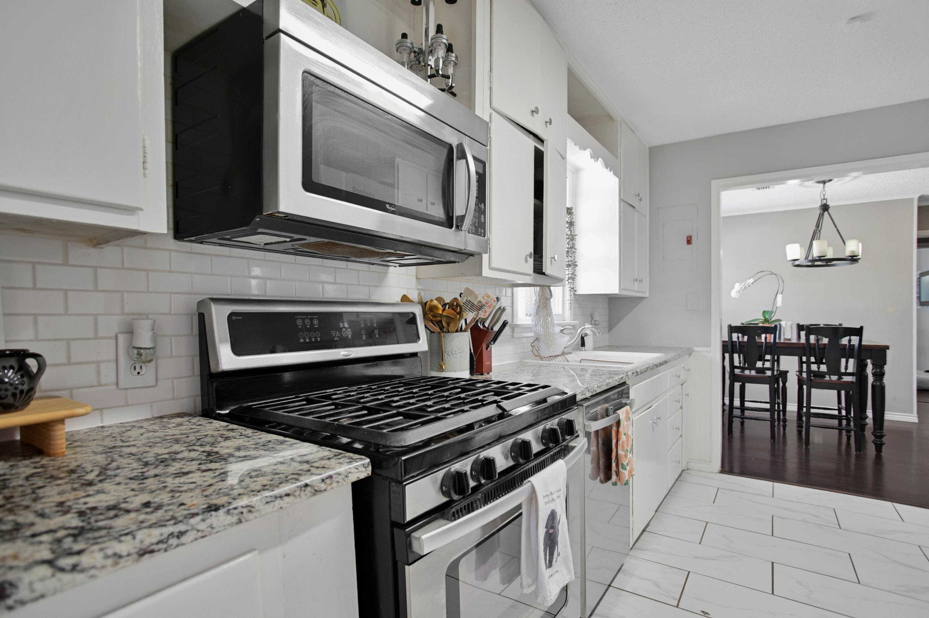 4102 32nd Street Lubbock, TX 79410 - Photo 14 of 40 a kitchen with a stove and a microwave