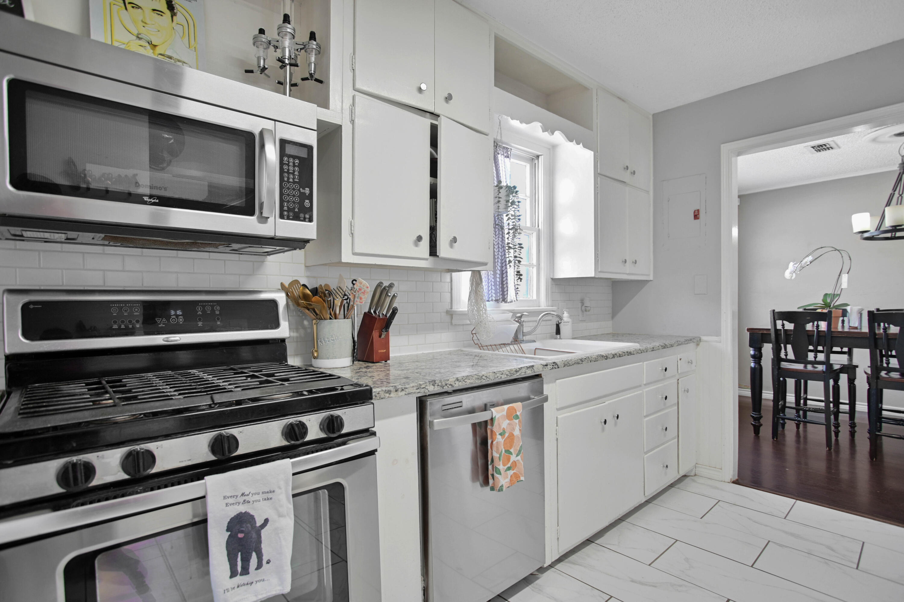 4102 32nd Street Lubbock, TX 79410 - Photo 15 of 40 a kitchen with granite countertop a stove and a sink