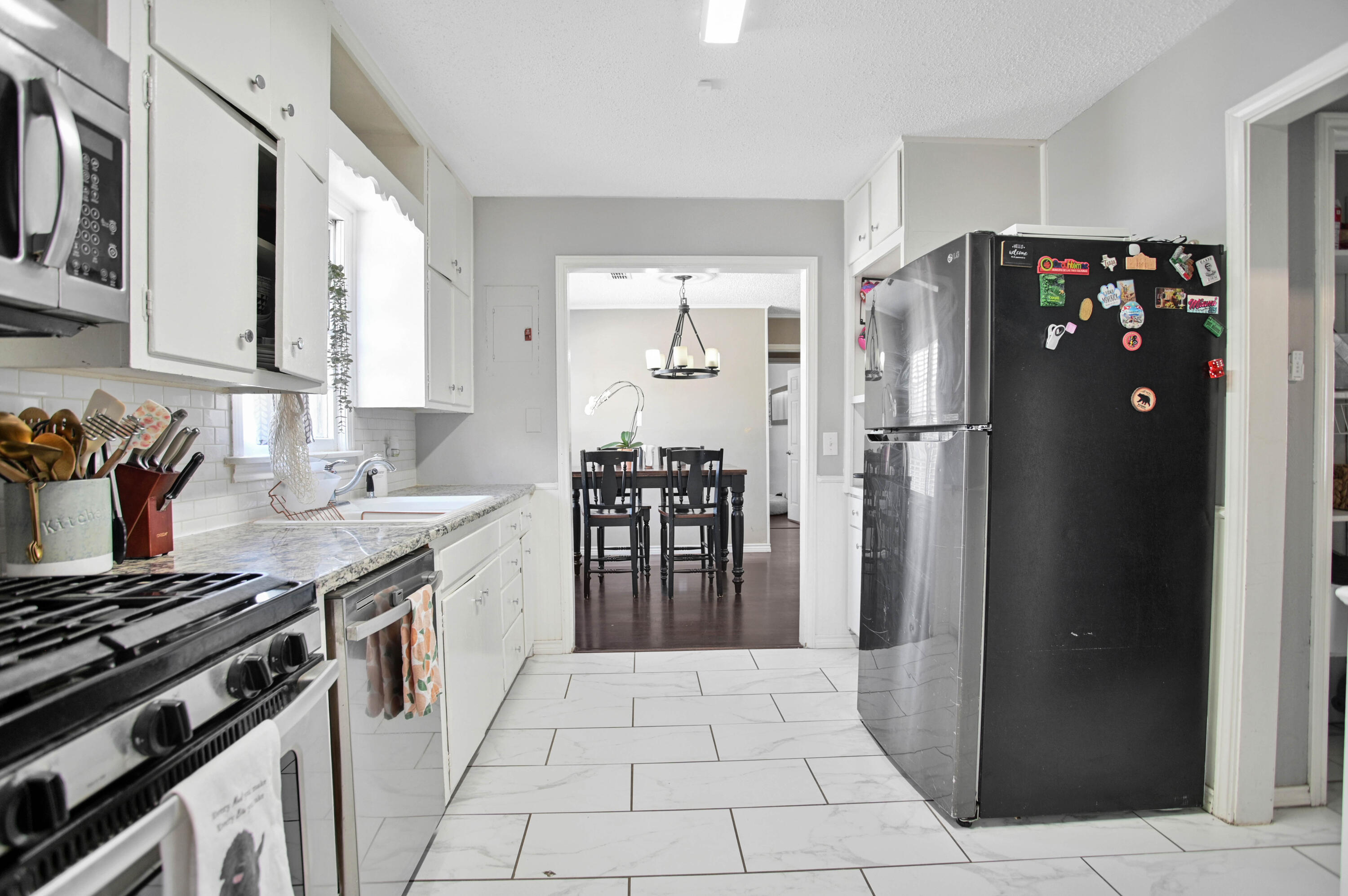 4102 32nd Street Lubbock, TX 79410 - Photo 16 of 40 a kitchen with stainless steel appliances granite countertop a refrigerator and a stove