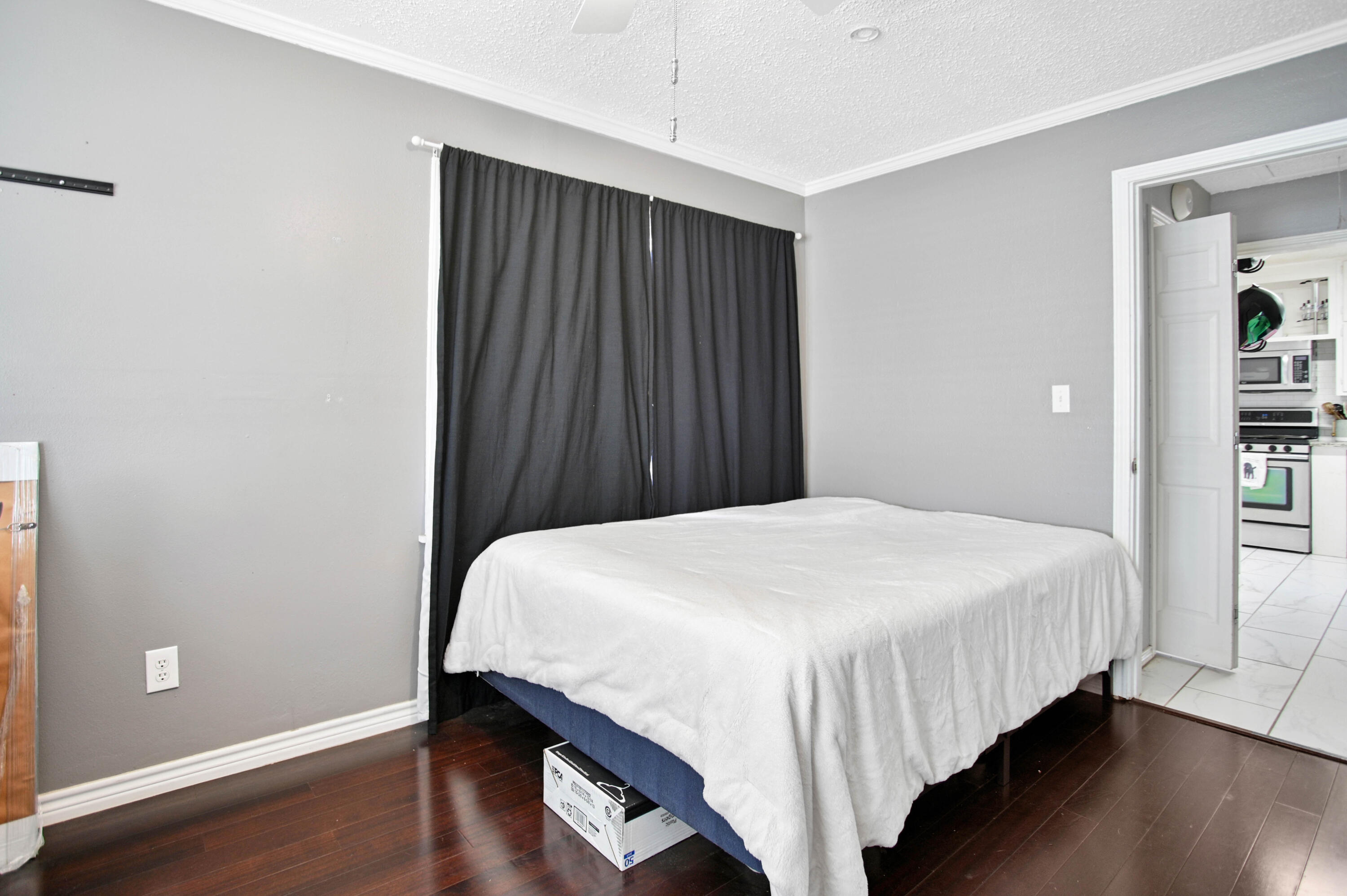 4102 32nd Street Lubbock, TX 79410 - Photo 20 of 40 a bedroom with a bed and wooden floor