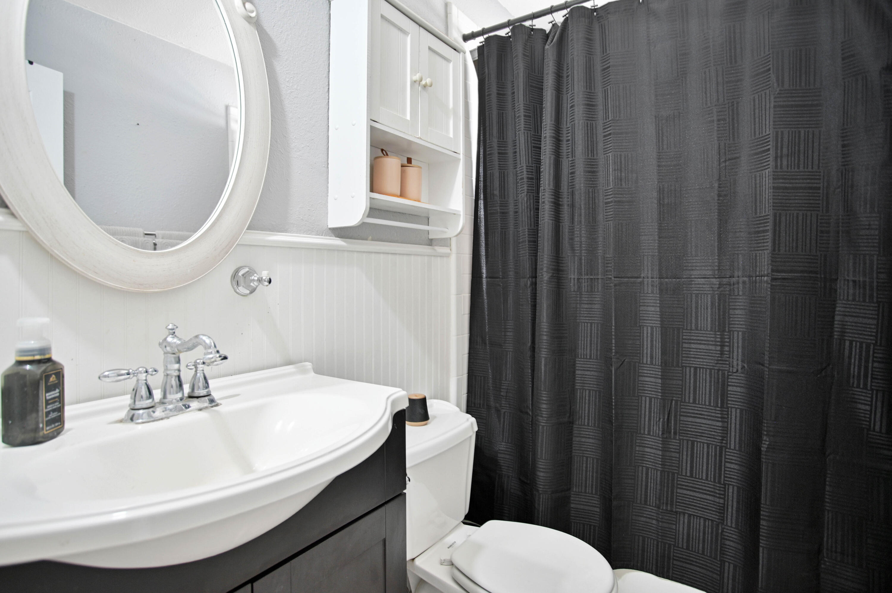 4102 32nd Street Lubbock, TX 79410 - Photo 21 of 40 a bathroom with a sink a toilet and a mirror
