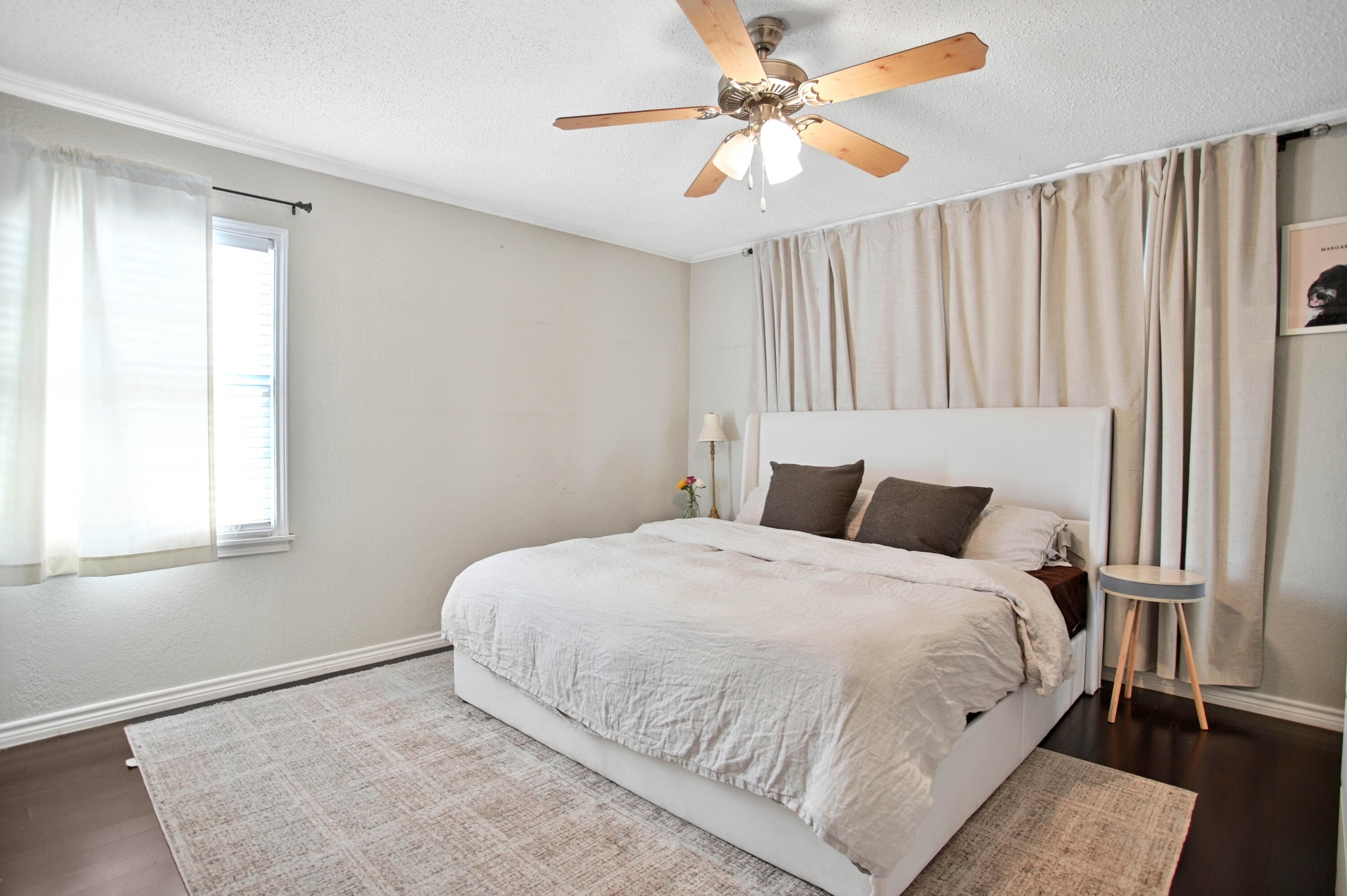 4102 32nd Street Lubbock, TX 79410 - Photo 22 of 40 a bedroom with a large bed and a chandelier