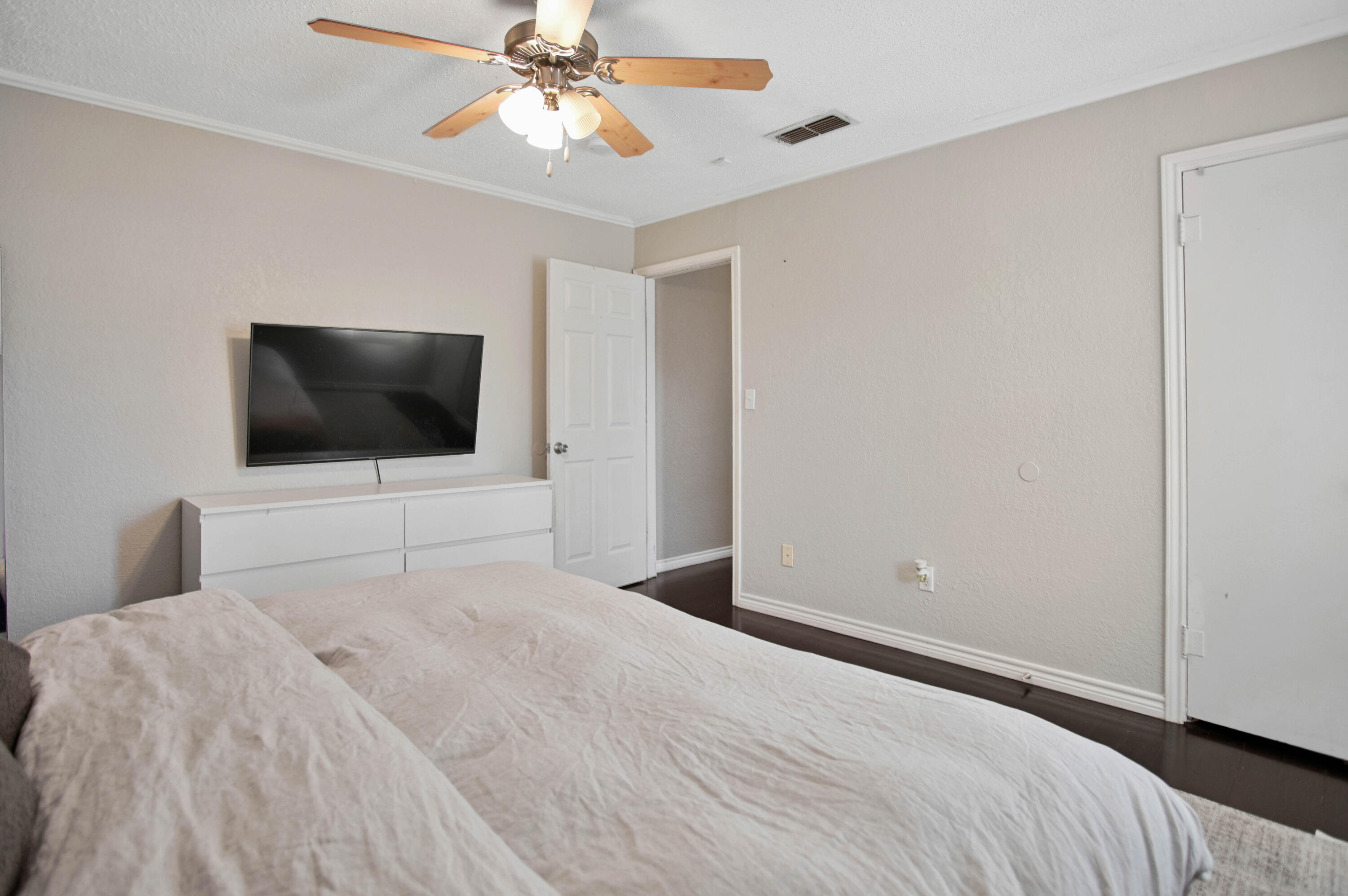 4102 32nd Street Lubbock, TX 79410 - Photo 24 of 40 a bedroom with a bed and a flat screen tv