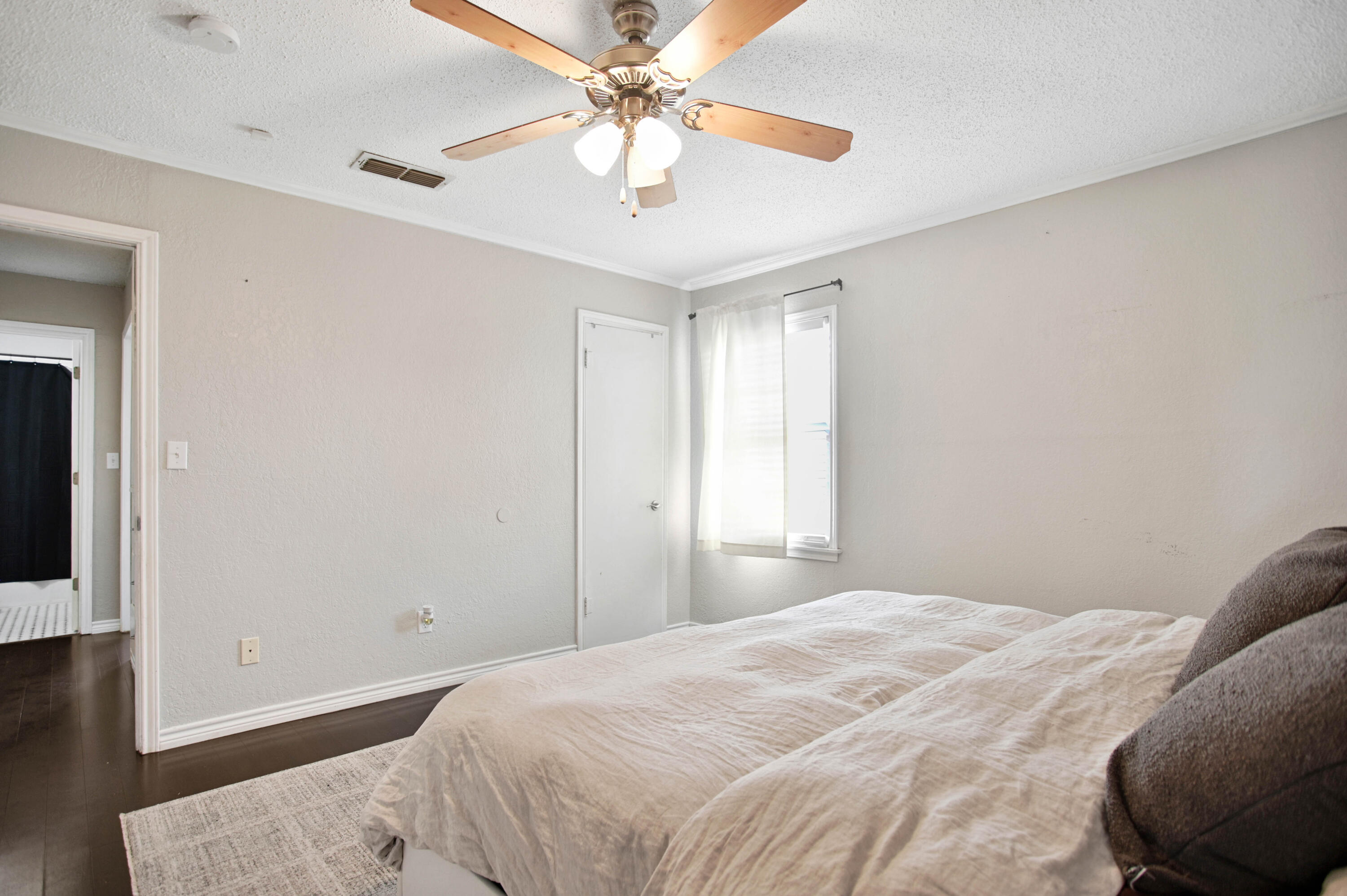4102 32nd Street Lubbock, TX 79410 - Photo 25 of 40 a bedroom with a large bed and a chandelier