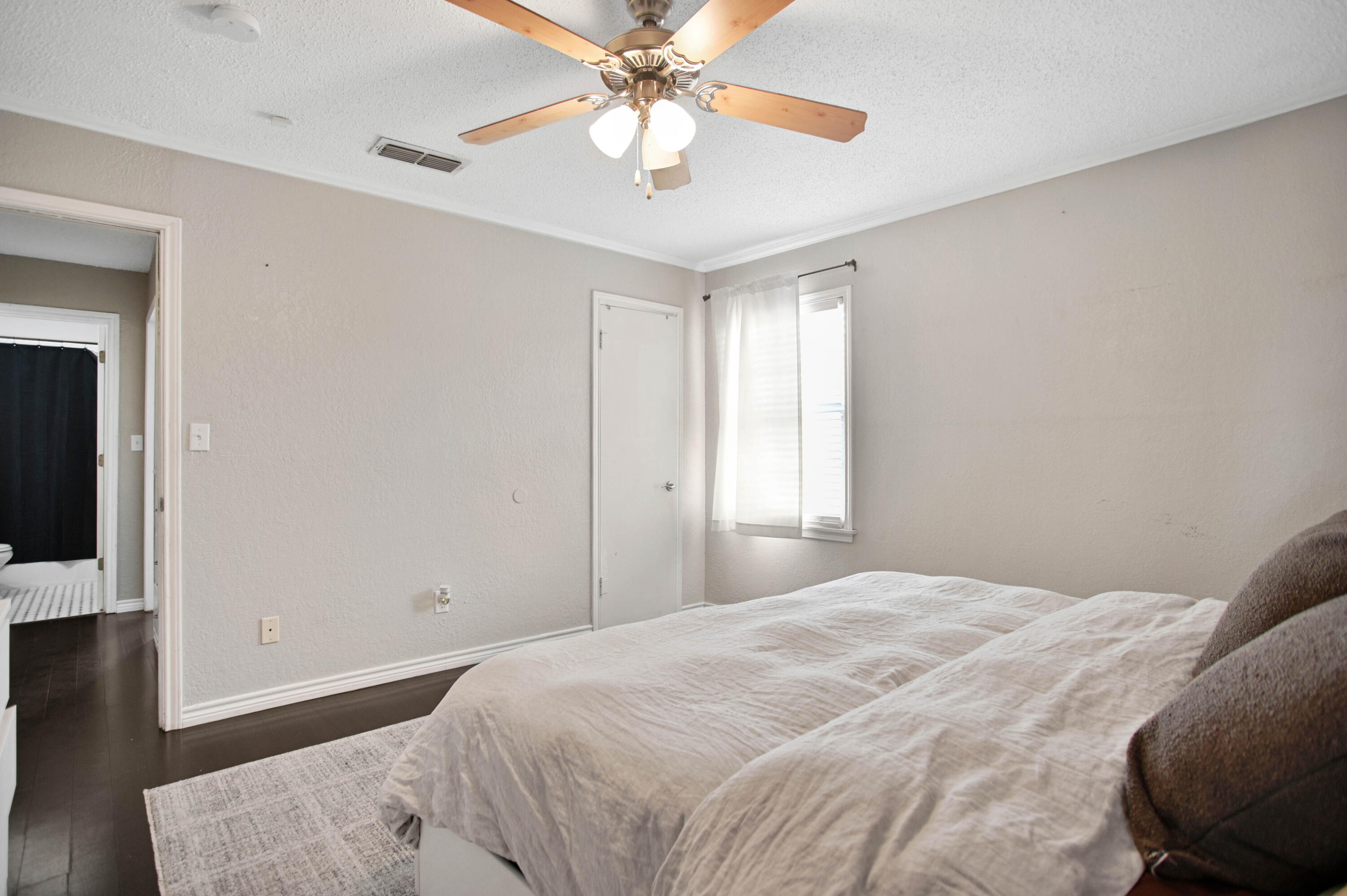 4102 32nd Street Lubbock, TX 79410 - Photo 26 of 40 a bedroom with a bed and a chandelier