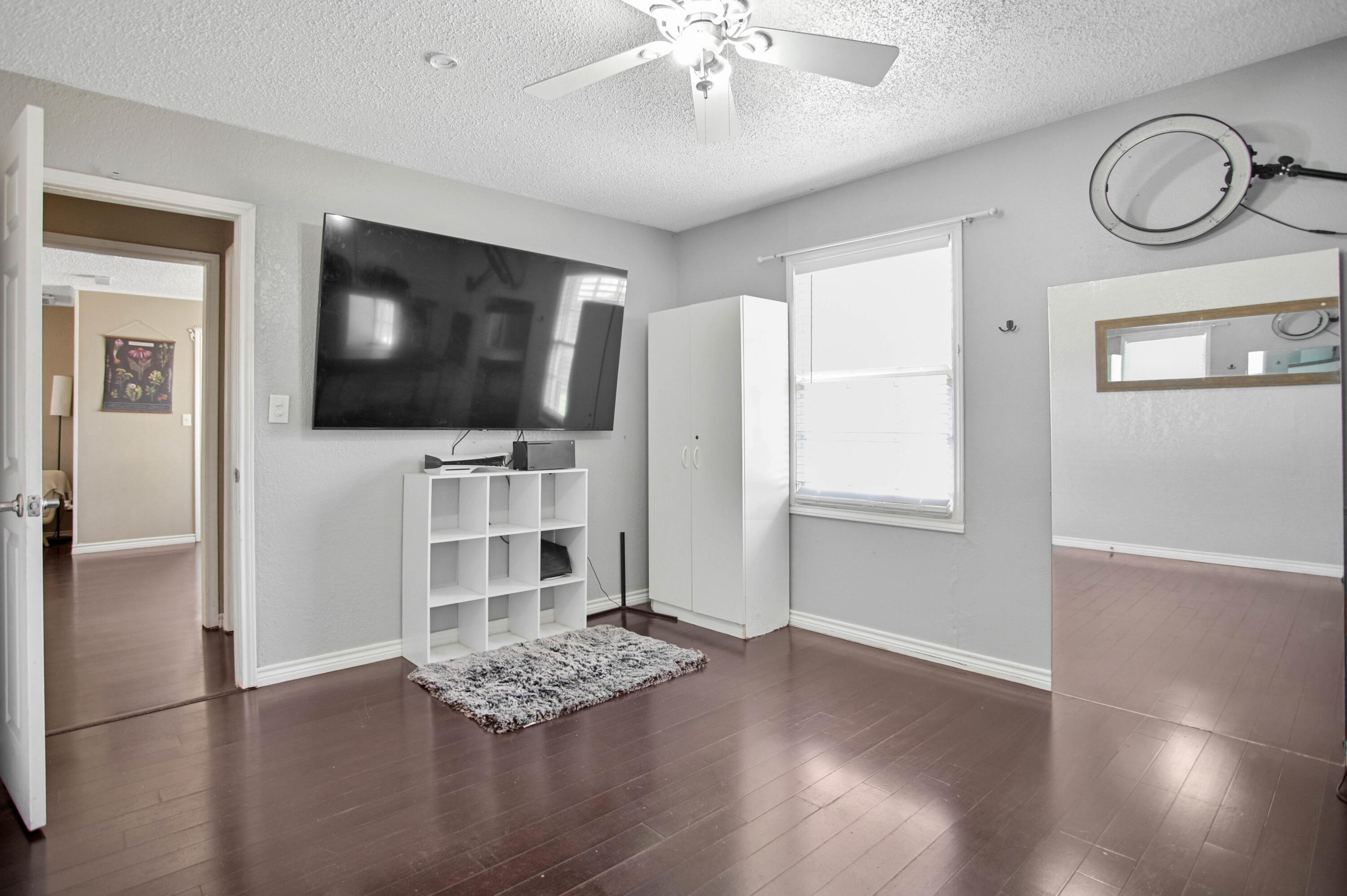 4102 32nd Street Lubbock, TX 79410 - Photo 29 of 40 a view of an empty room with wooden floor and a window