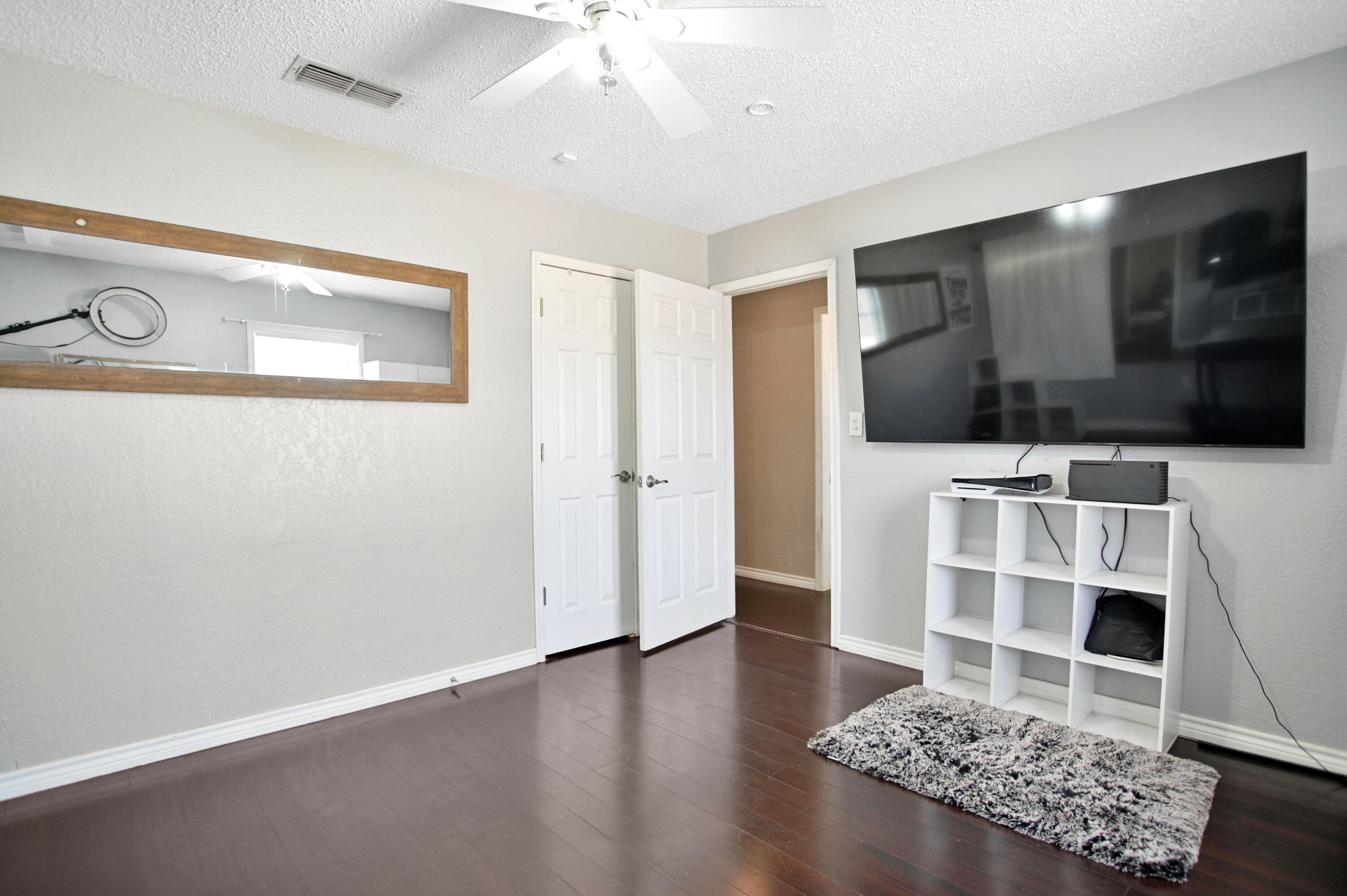 4102 32nd Street Lubbock, TX 79410 - Photo 30 of 40 a living room with a flat screen tv and rug
