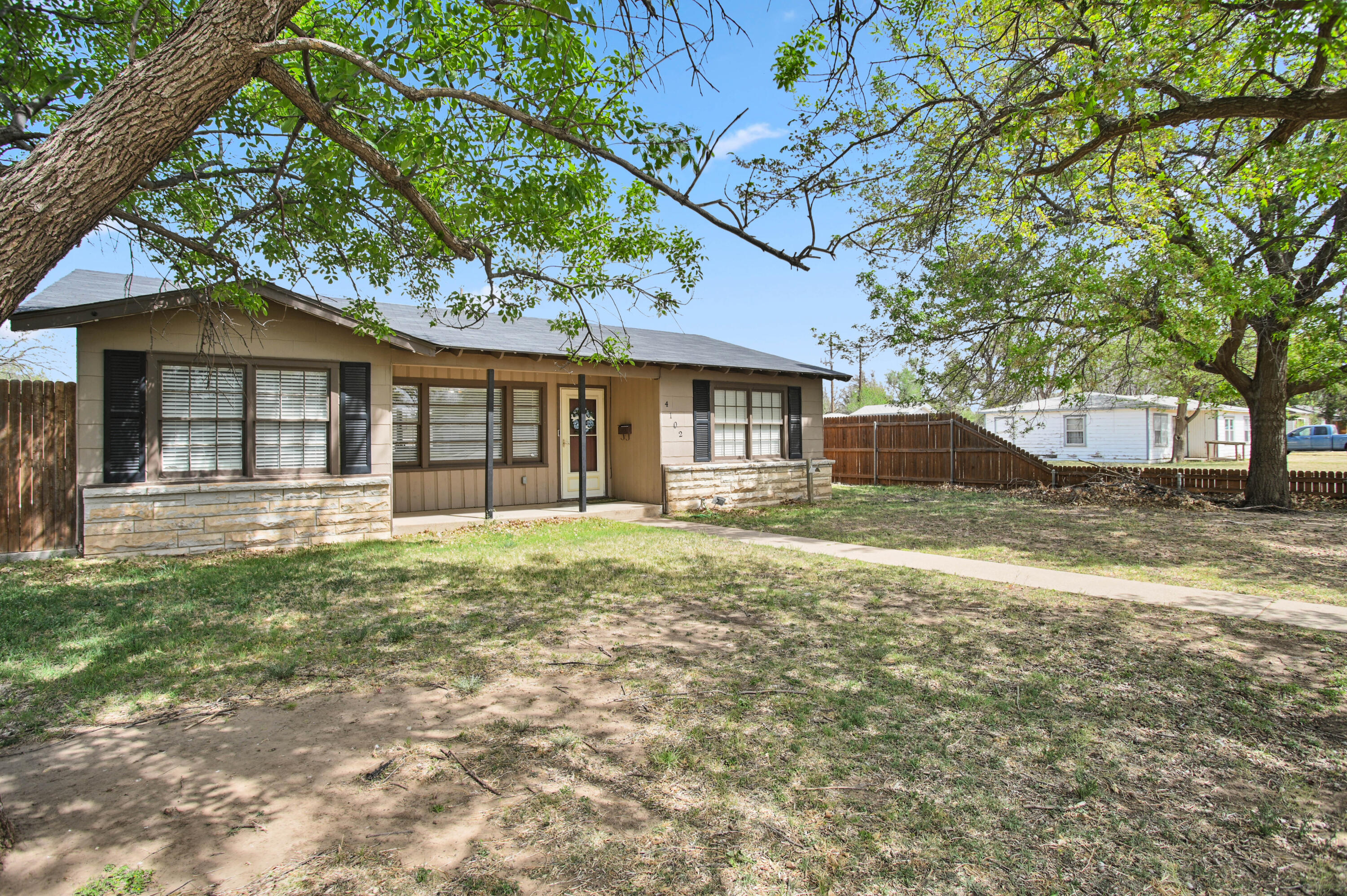 4102 32nd Street Lubbock, TX 79410 - Photo 3 of 40 a front view of a house with a garden