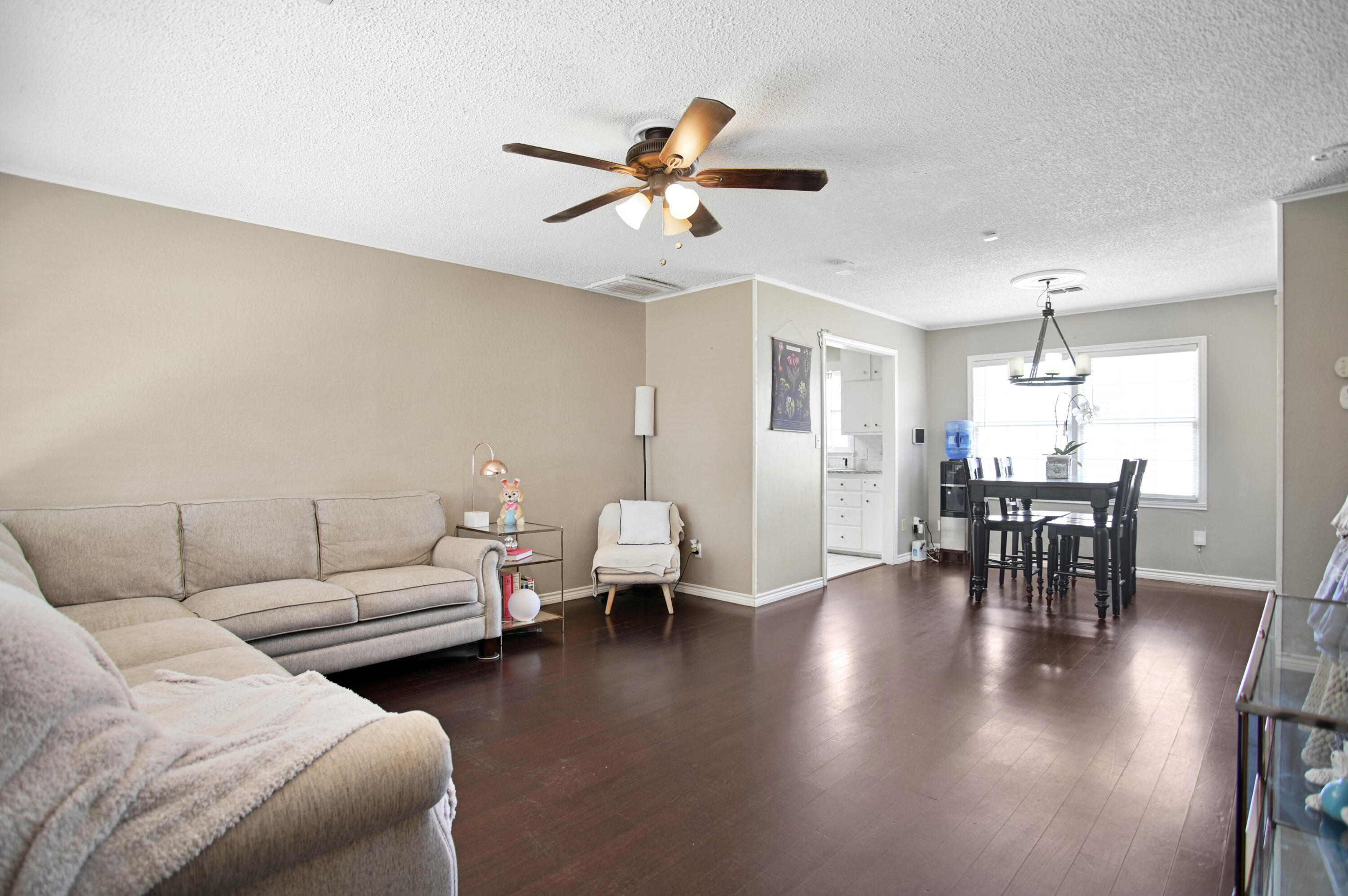 4102 32nd Street Lubbock, TX 79410 - Photo 4 of 40 a living room with furniture and a dining table with wooden floor
