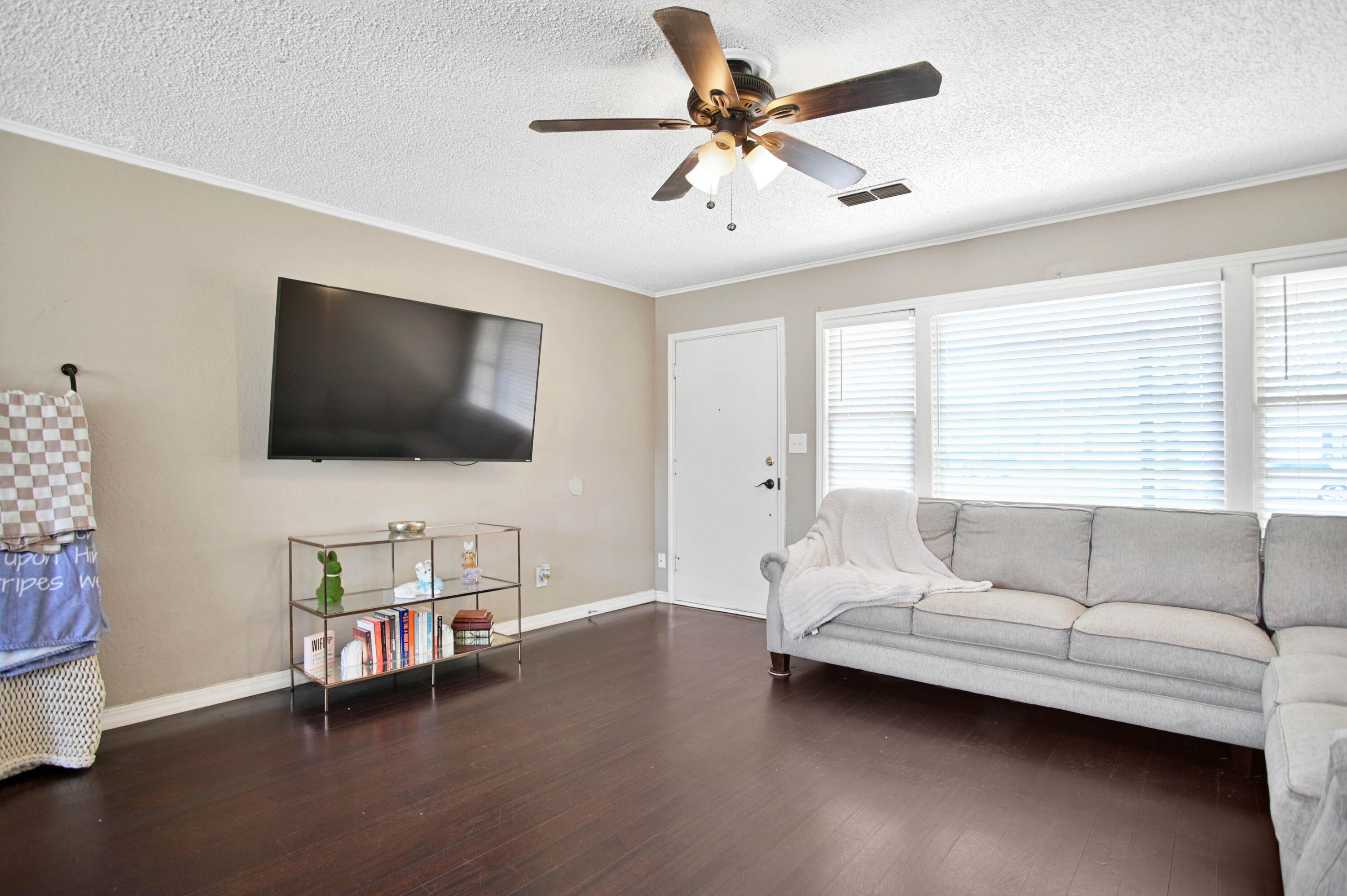 4102 32nd Street Lubbock, TX 79410 - Photo 7 of 40 a living room with furniture and a flat screen tv
