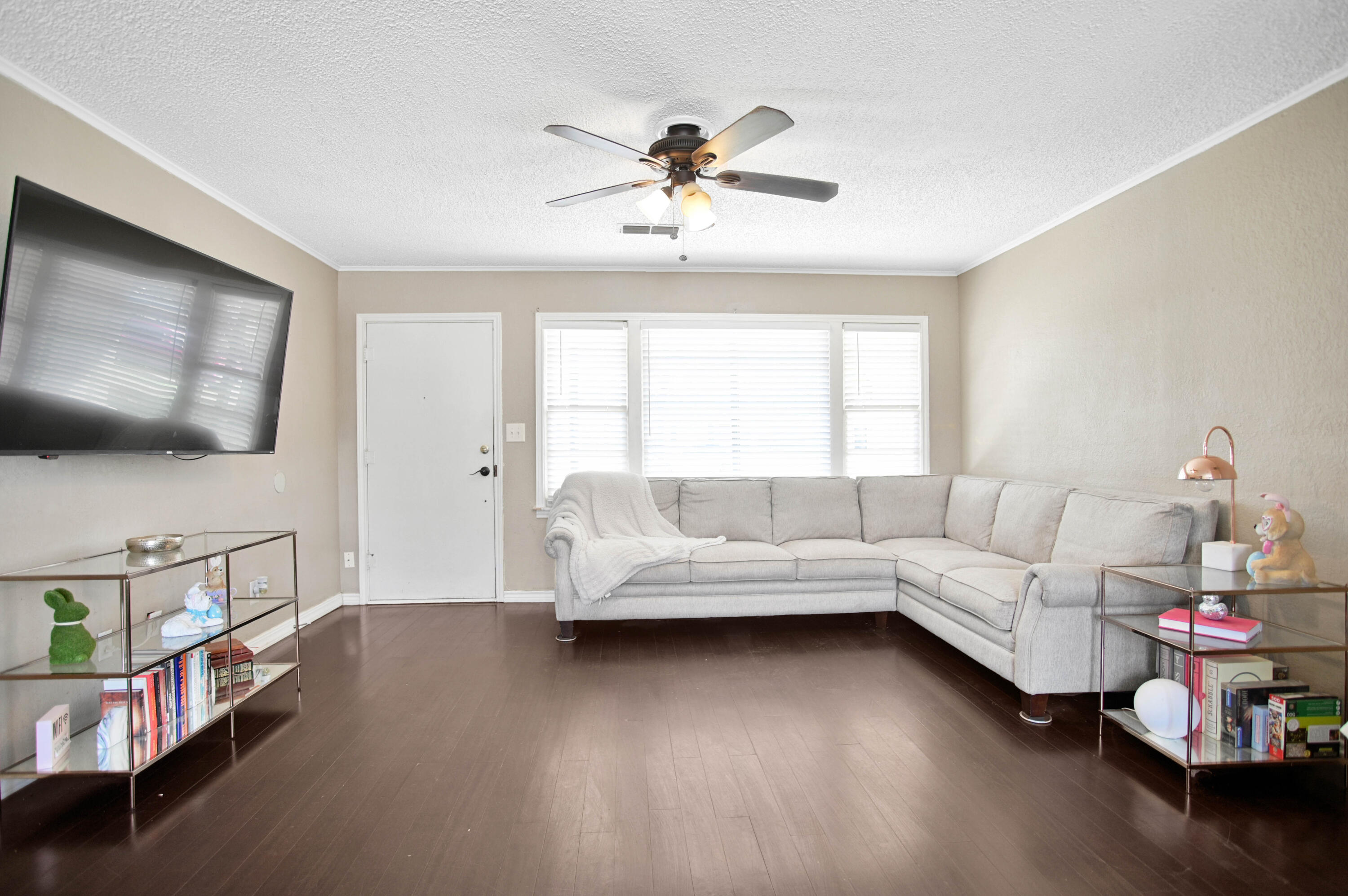 4102 32nd Street Lubbock, TX 79410 - Photo 8 of 40 a living room with furniture and a flat screen tv