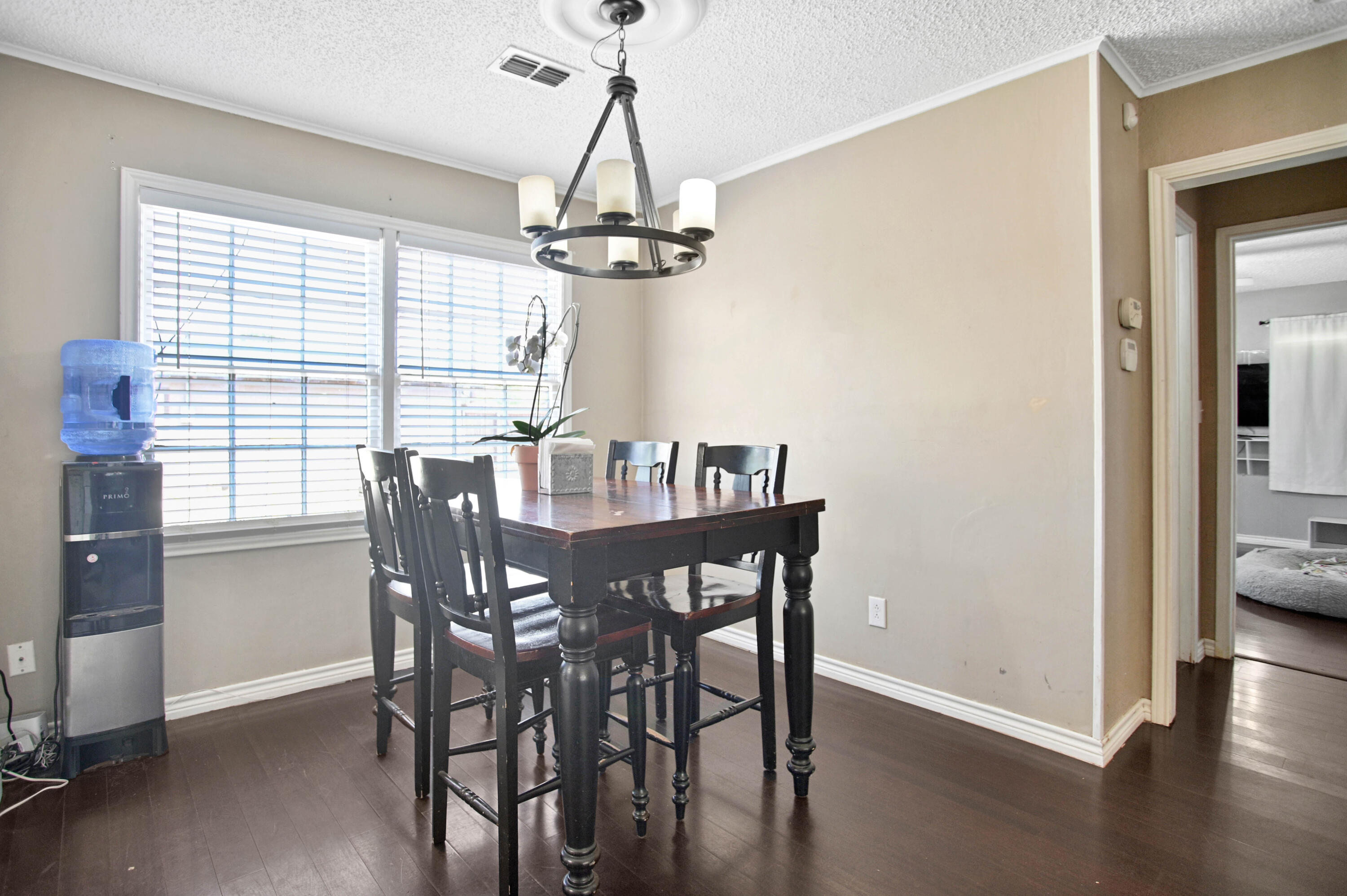 4102 32nd Street Lubbock, TX 79410 - Photo 10 of 40 a view of a dining room with furniture window and wooden floor