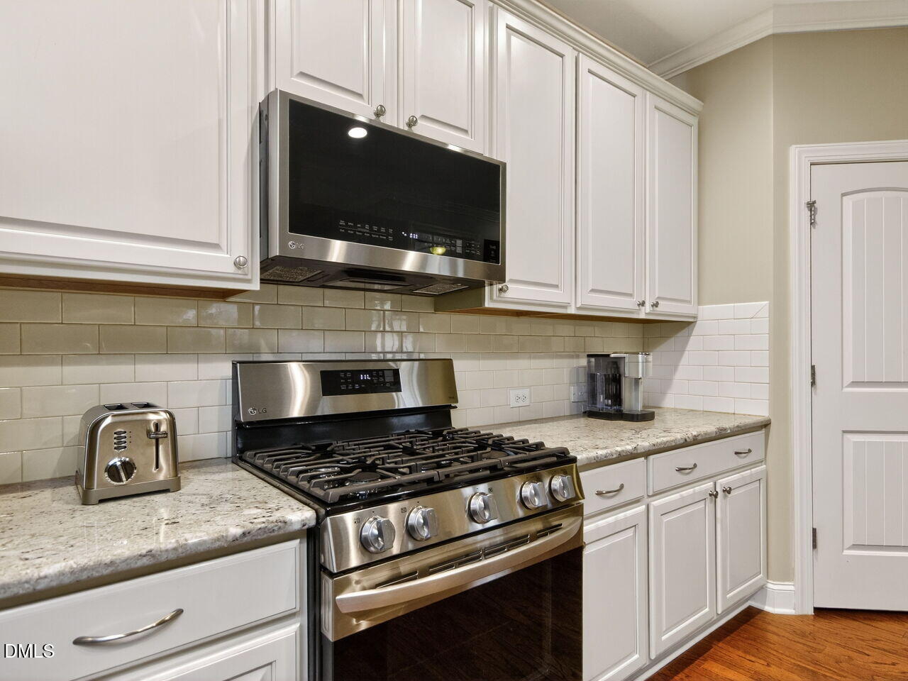 1133 Chapanoke Road Raleigh, NC 27603 - Photo 16 of 48 a kitchen with granite countertop a stove and a sink