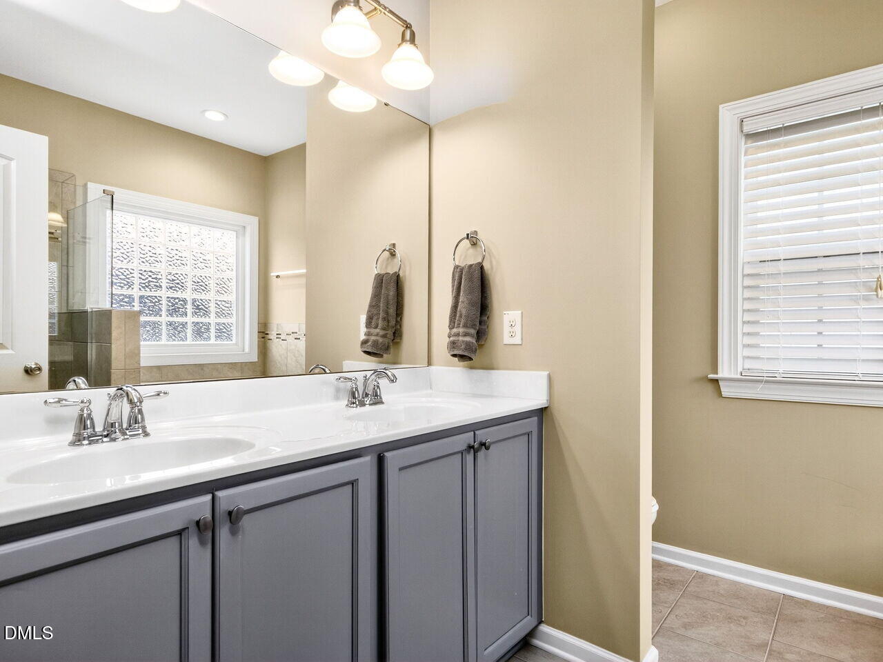 1133 Chapanoke Road Raleigh, NC 27603 - Photo 20 of 48 a bathroom with a sink a vanity and a mirror
