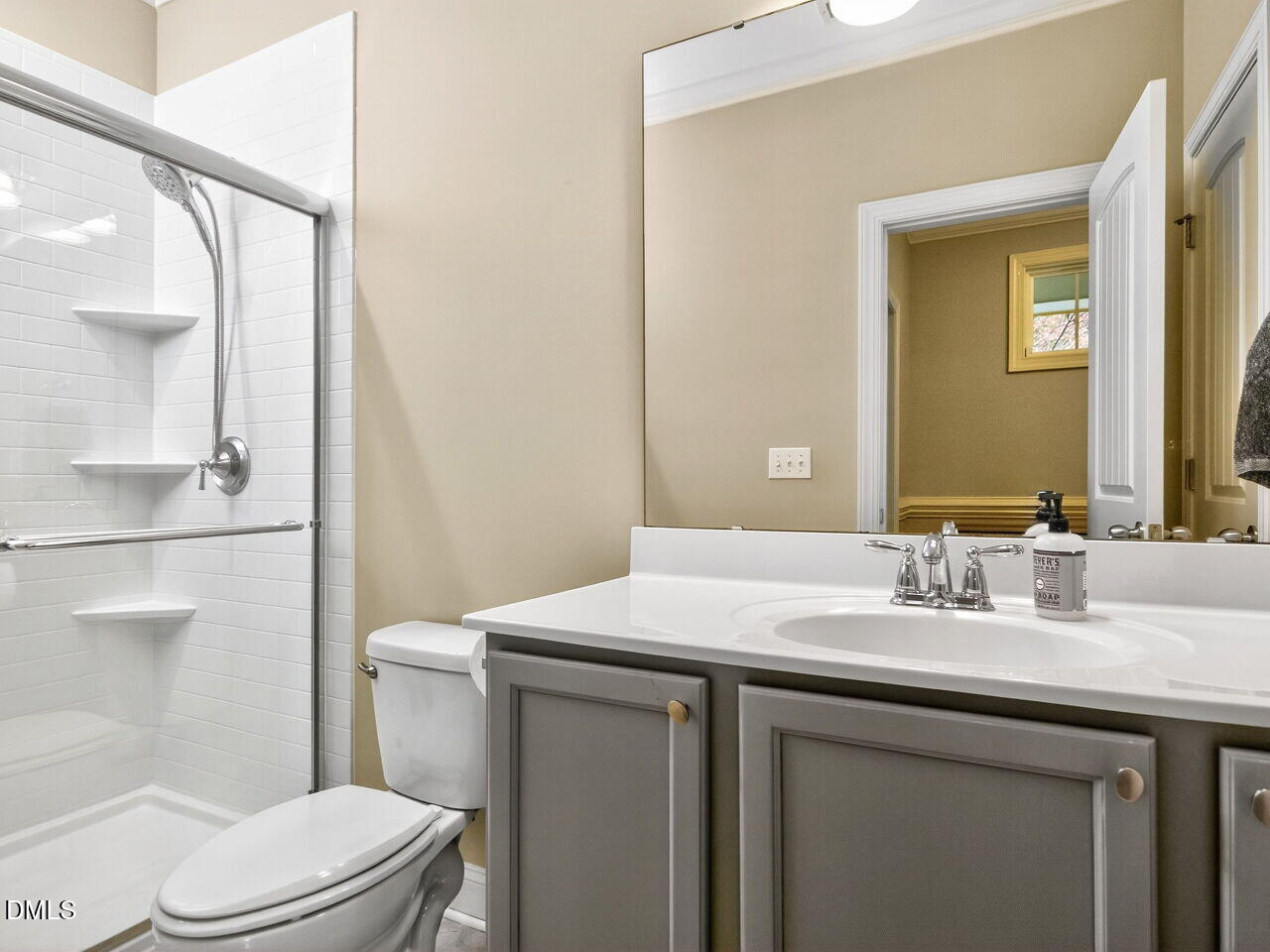 1133 Chapanoke Road Raleigh, NC 27603 - Photo 6 of 48 a bathroom with a sink a toilet a mirror and shower