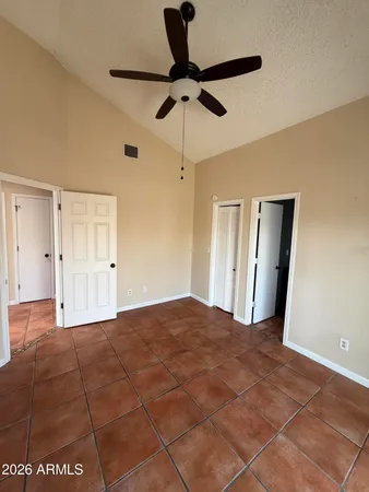 a view of empty room with a ceiling fan