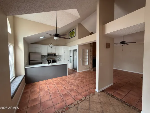 a large kitchen with stainless steel appliances granite countertop a refrigerator and a sink