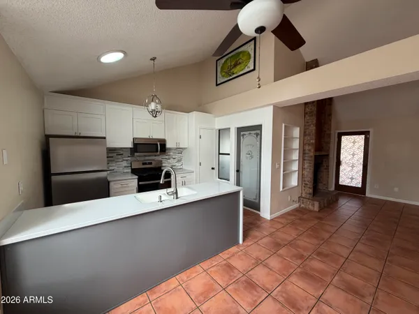 a kitchen with stainless steel appliances a refrigerator and a stove top oven