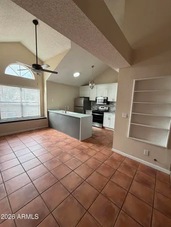 a large kitchen with a stove a sink dishwasher and a refrigerator