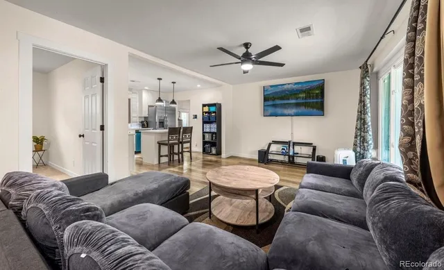 a living room with furniture and a chandelier