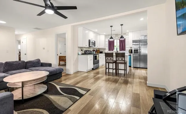 a living room with furniture and kitchen view